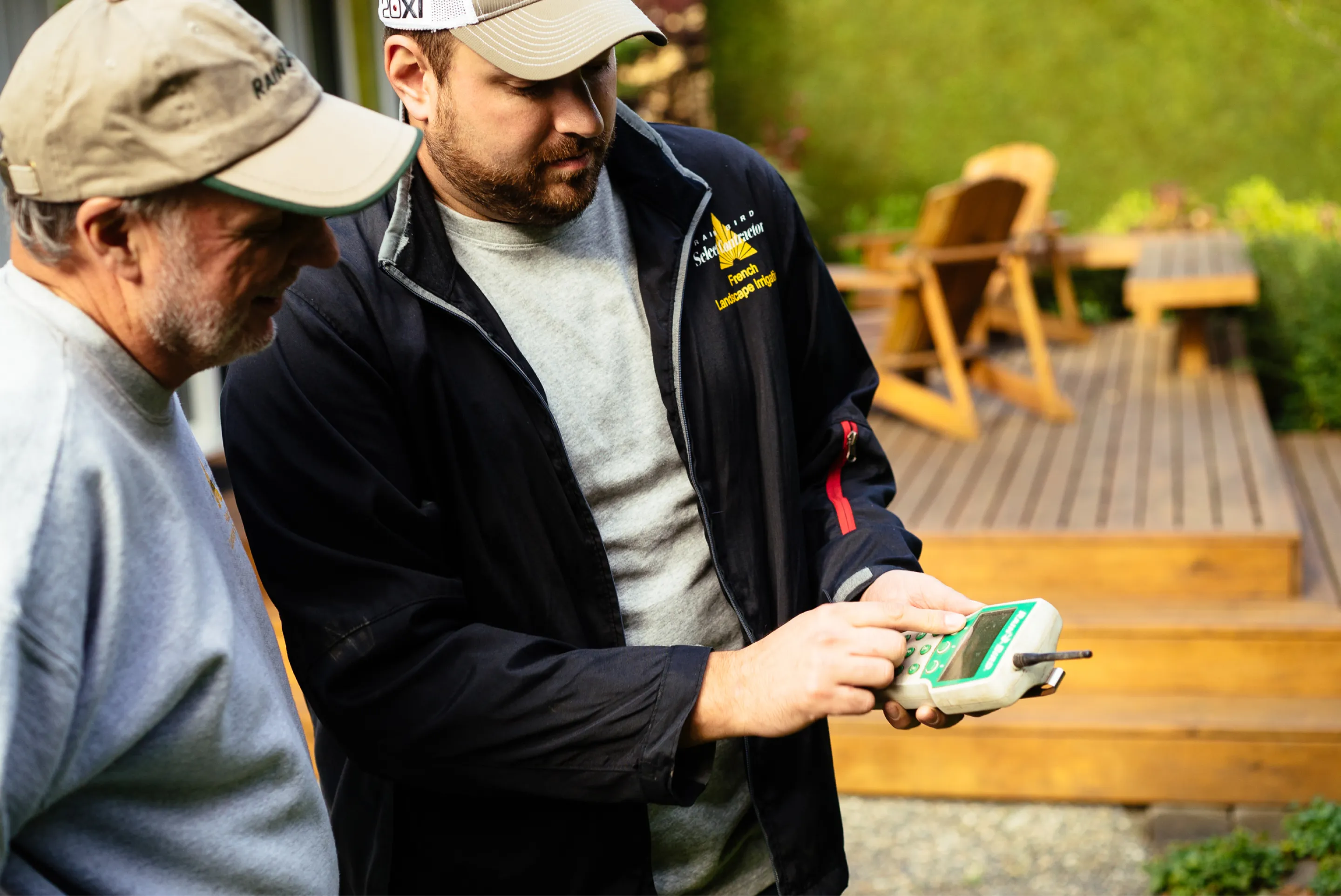 Owners of French Landscape Irrigation showing a device they use on the job